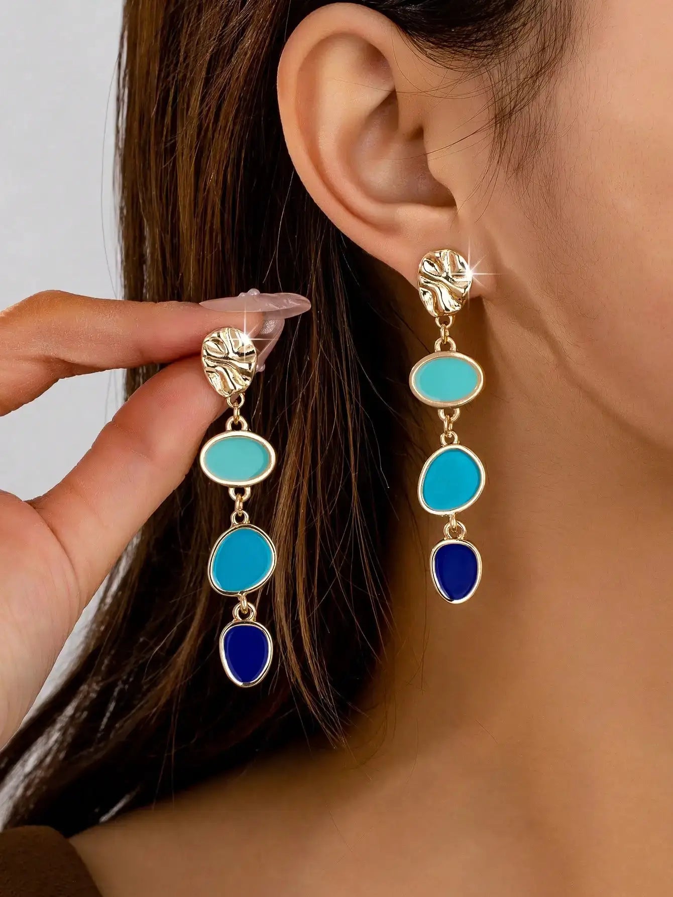 Oil-drip gold-tone earrings with turquoise and blue oval stones, drop-style pair