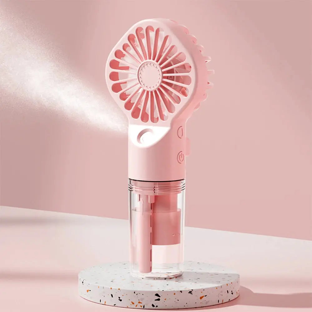 Pink portable handheld spray fan with built-in humidifier and water reservoir, 4-speed USB-rechargeable mist fan