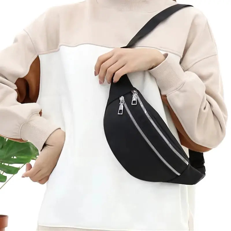 Simples Market black fanny pack waist bag with dual zippers worn crossbody.
