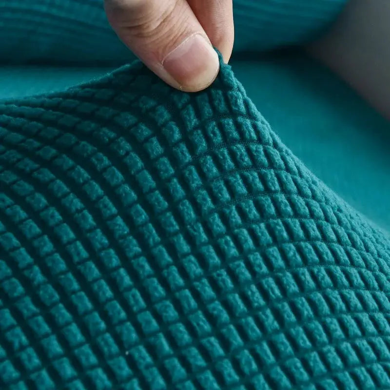 Thick quilted elastic sofa cover in solid teal for living room furniture protection