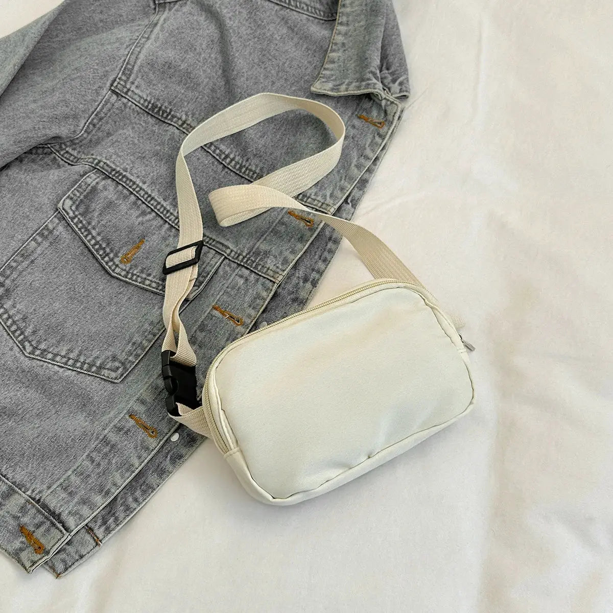 Cream sport waist bag with beige adjustable strap and black buckle, crossbody phone pouch