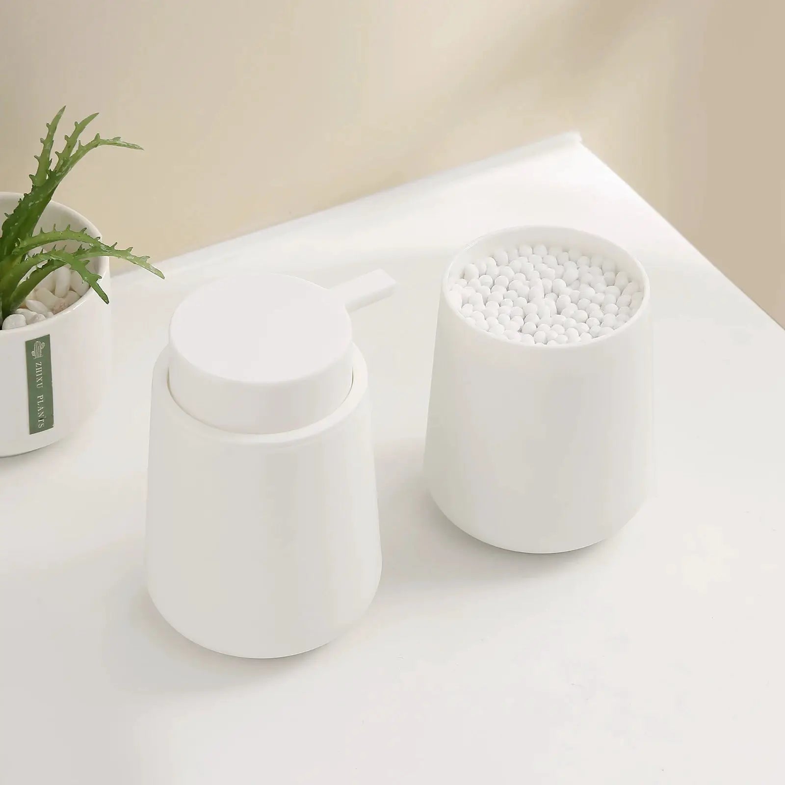 Bathroom accessory set: white matte 2-piece soap dispenser and bead-filled cup for vanity decor