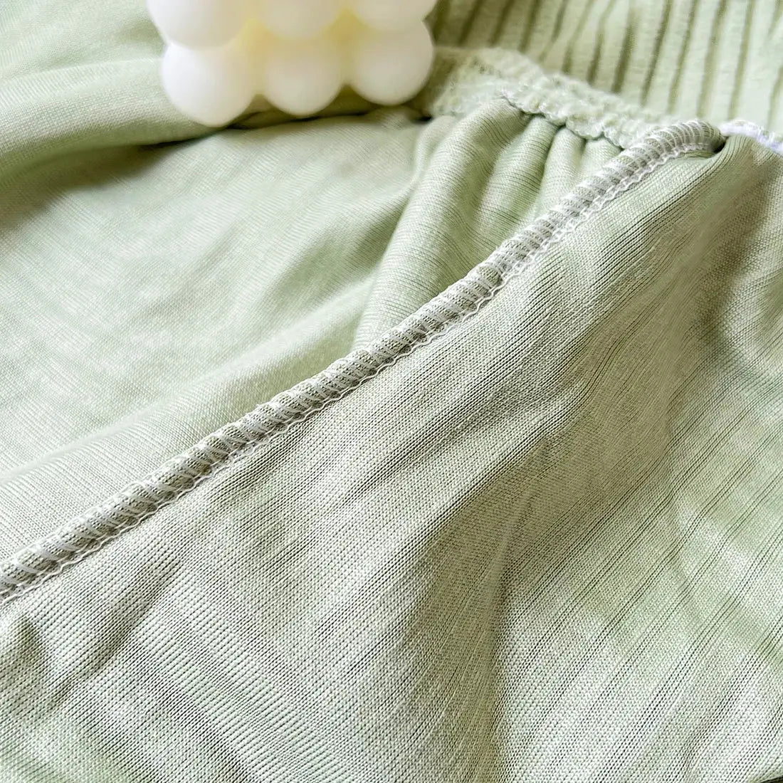 Sofa seat cushion cover in sage green jacquard fabric with stretch; removable and washable.