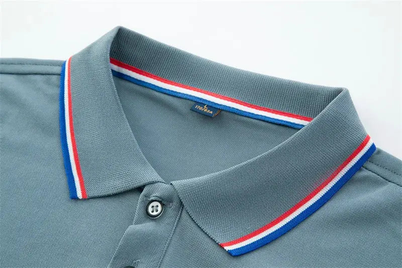 Men's short-sleeved polo shirt in blue-gray, solid color with red, white, and blue striped collar trim.