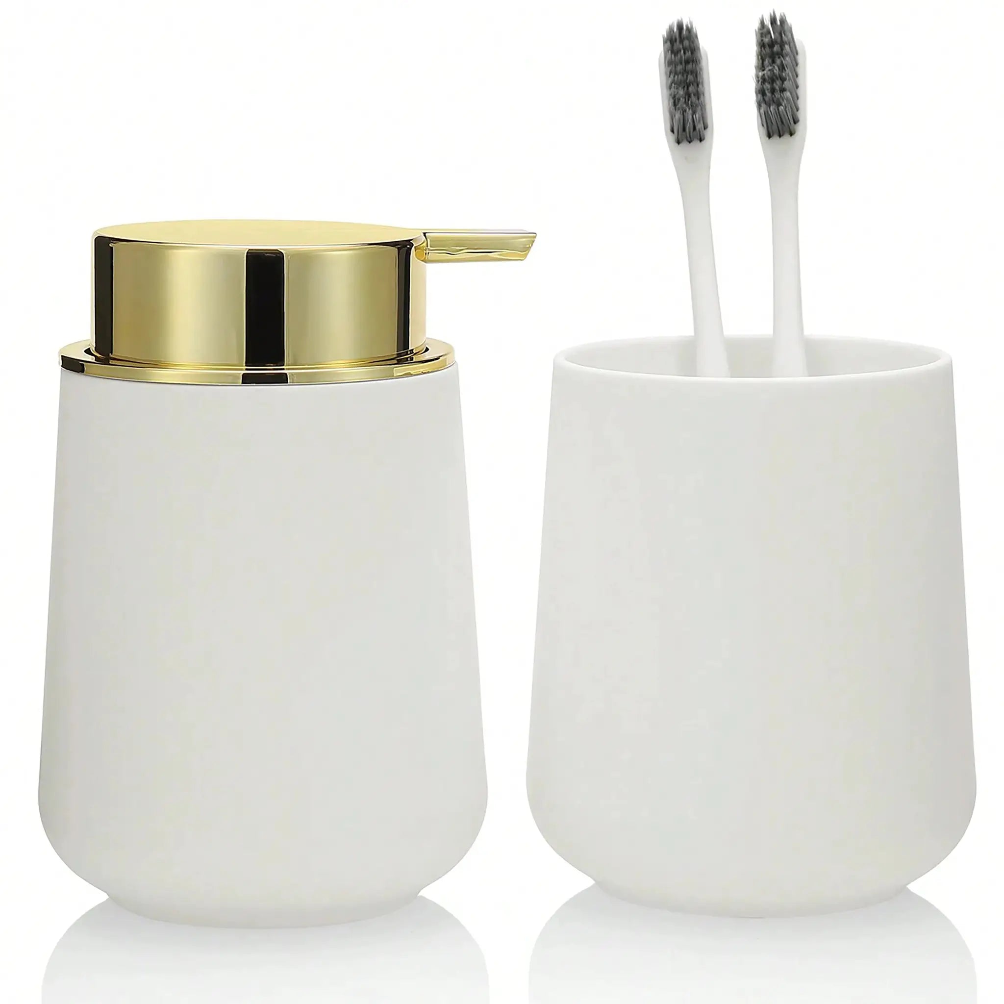 Bathroom accessory set: white soap dispenser with gold lid and white toothbrush cup with two brushes.