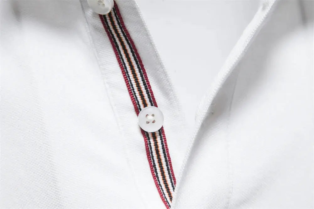 Men's white cotton polo shirt with striped placket, short sleeves and white button detail.