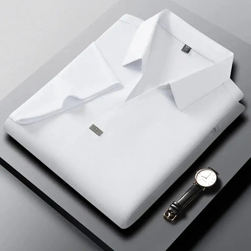 Simples Market men's white short-sleeved polo shirt, solid color, folded on a desk with a wristwatch.