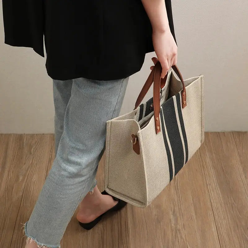Canvas stripe bucket tote bag by Simples Market with brown leather top handles, large capacity