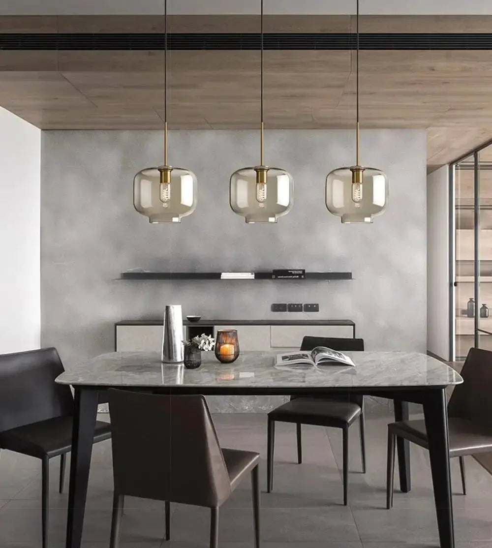 Nordic LED glass chandelier, three glass pendant lights with brass fittings over a marble dining table