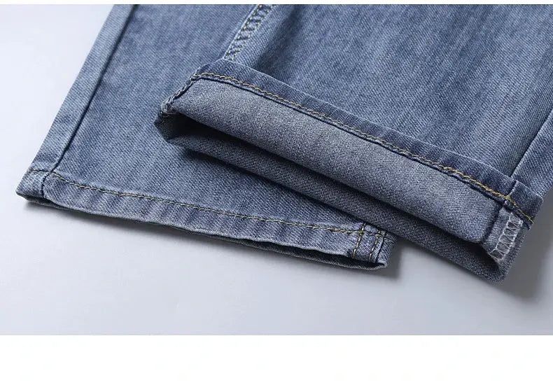 Men's blue denim jeans with cotton stretch, rolled cuff close-up