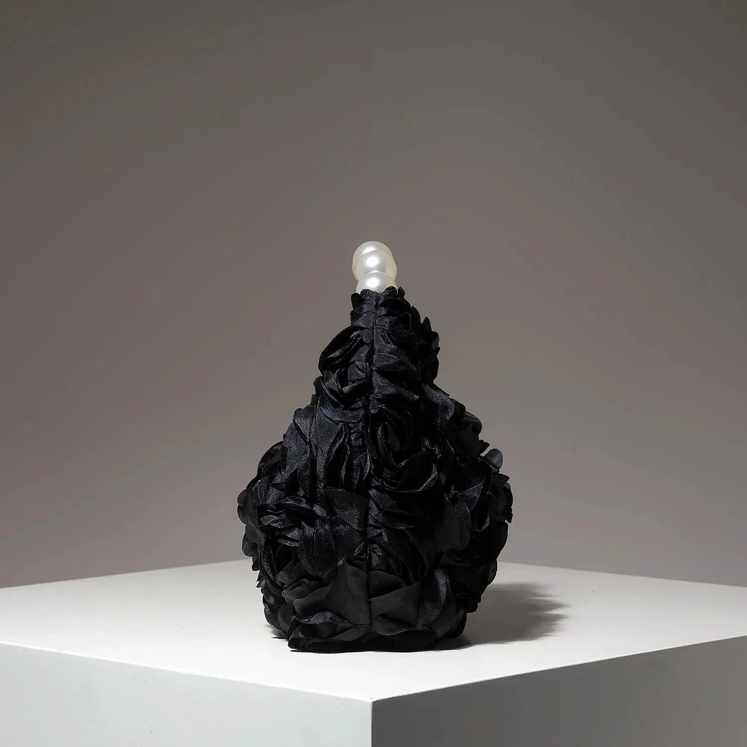 Clutch bag in black floral-ruffled fabric with a pearl bead top handle, elegant evening bag