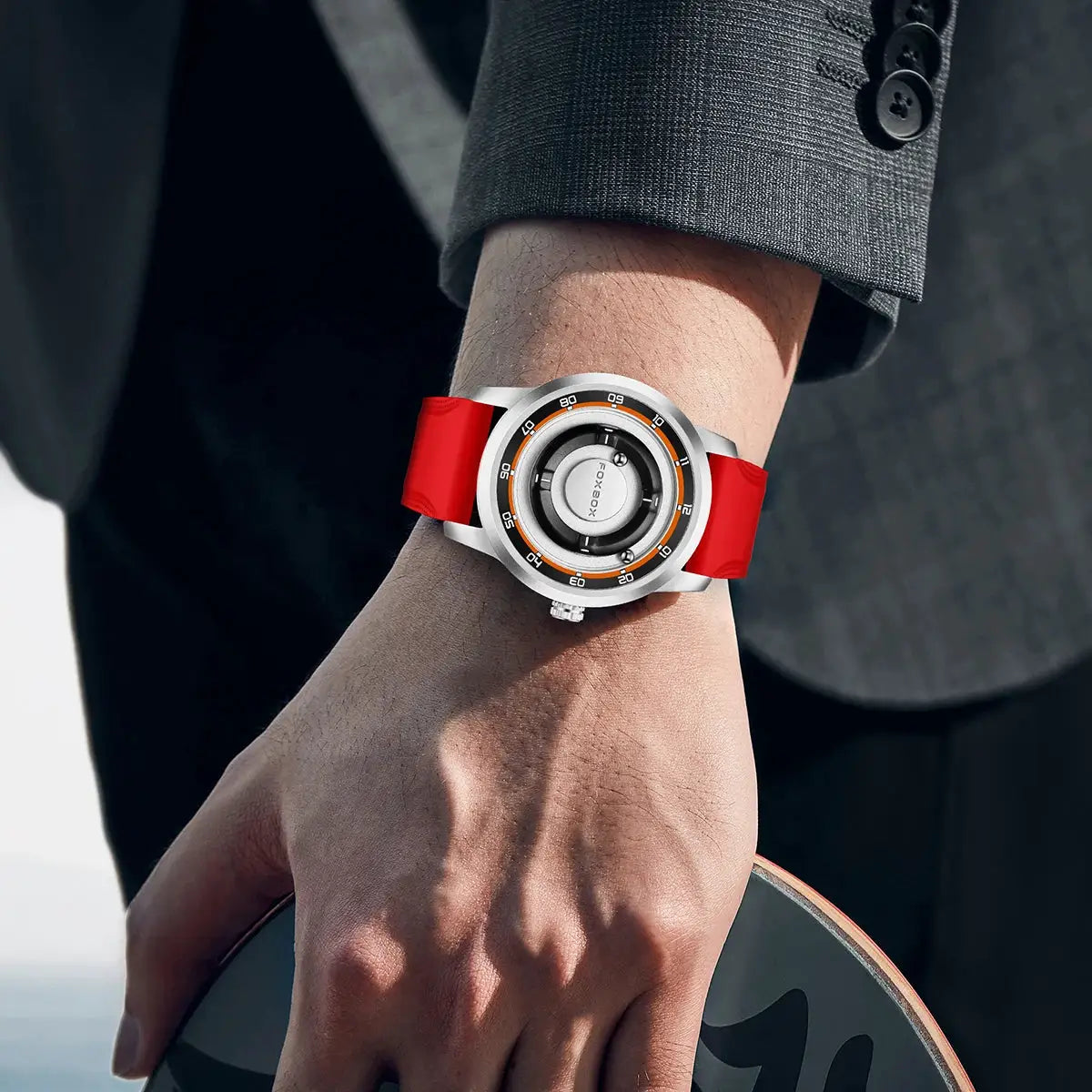 FOXBOX watch on wrist with red silicone strap, silver case and orange ring