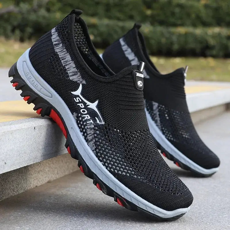 Men's black mesh sport sneakers, a pair by Simples Market with breathable knit upper and red outsole.