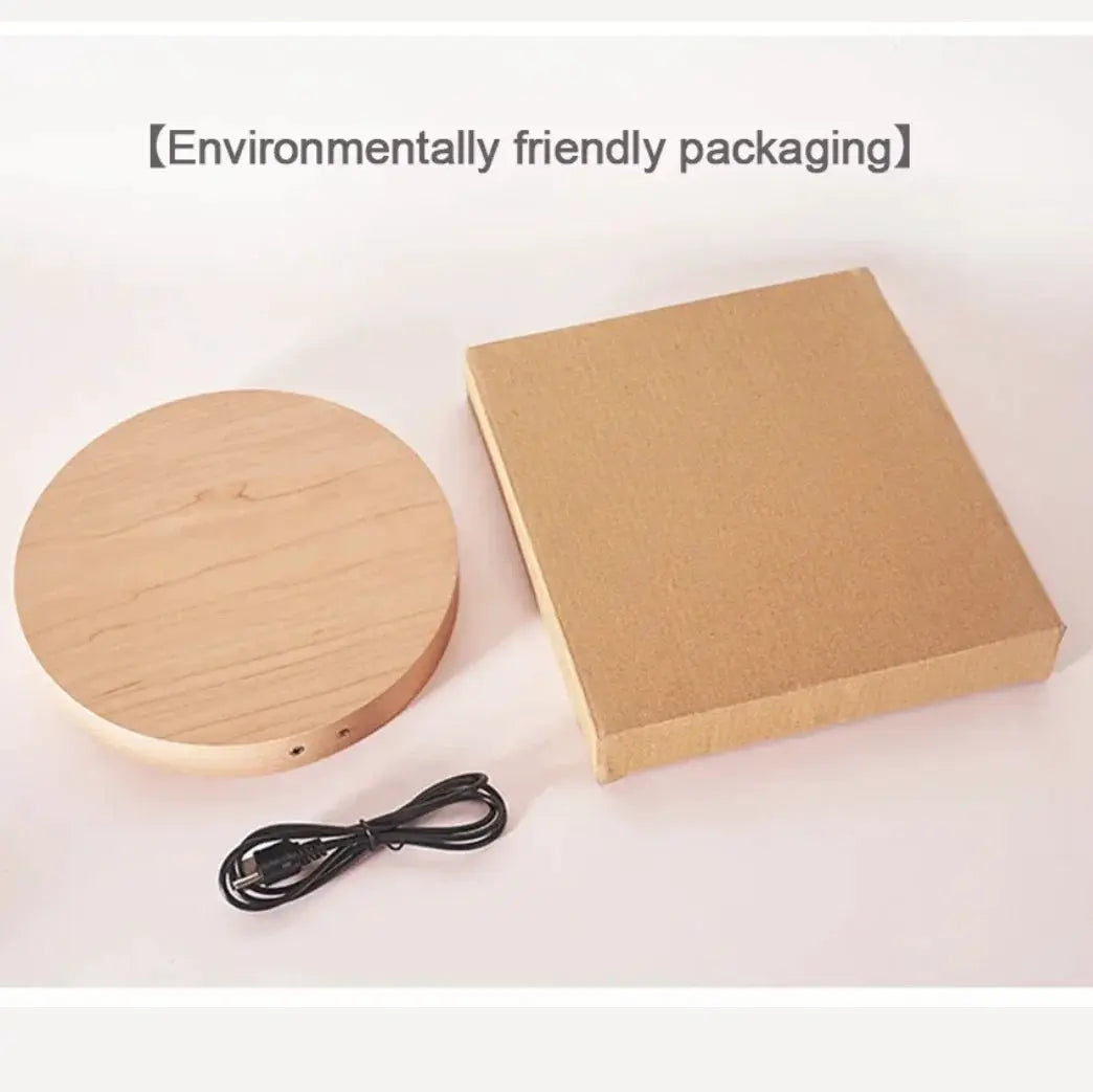 LED digital wall clock packaging: three components - round wooden base, brown cardboard box, USB power cable.