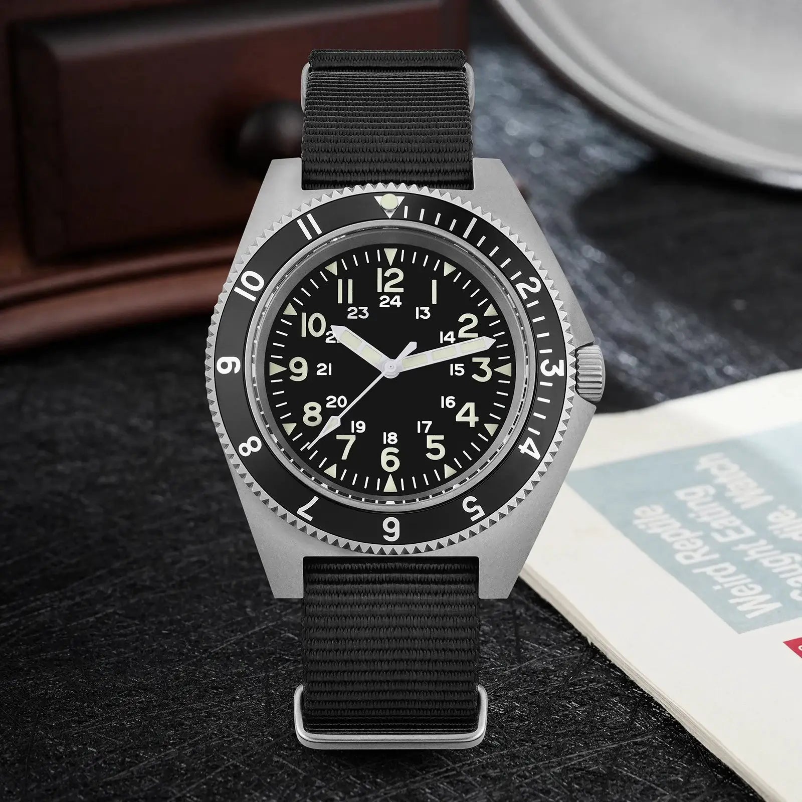 Watchdives WD1972 quartz field watch with gray case, black dial, luminous hands, and black fabric NATO strap