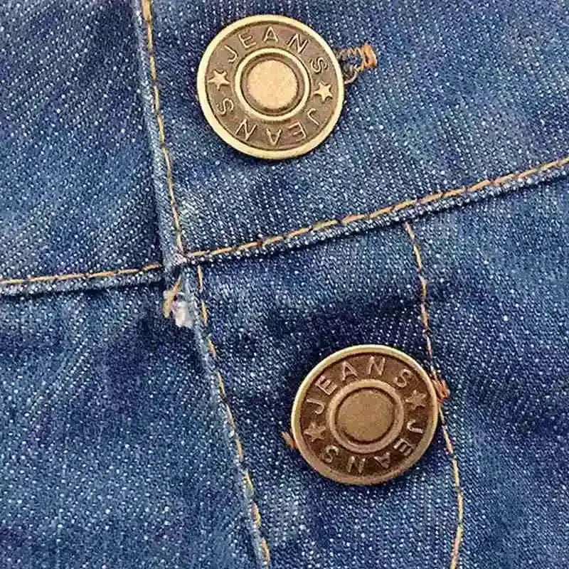 Women's blue denim shorts close-up with orange contrast stitching and brass-toned metal buttons, denim texture visible.