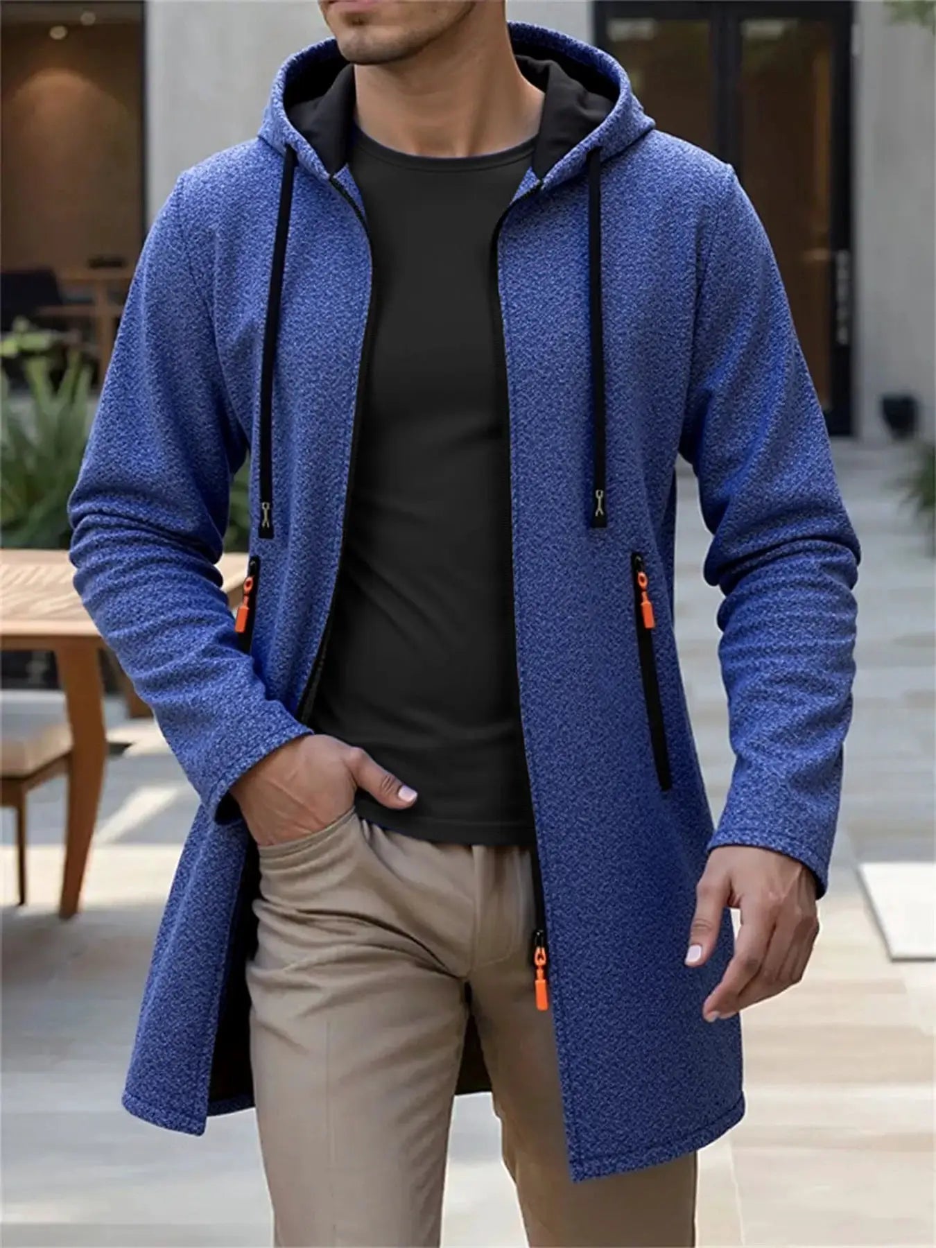 Men's blue knit hooded long cardigan jacket with black interior and orange zipper pulls