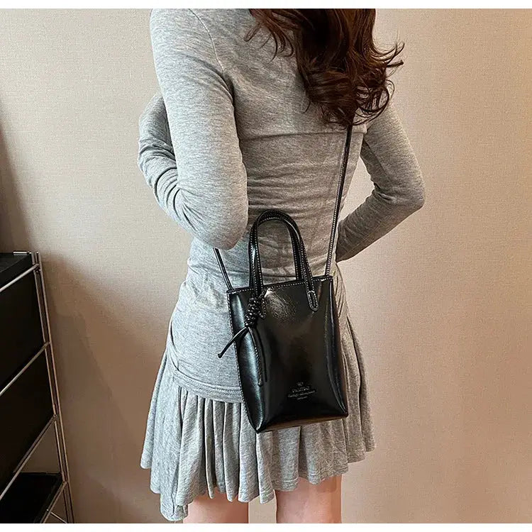 PU leather mini crossbody bag for women, black with top handles and a long shoulder strap