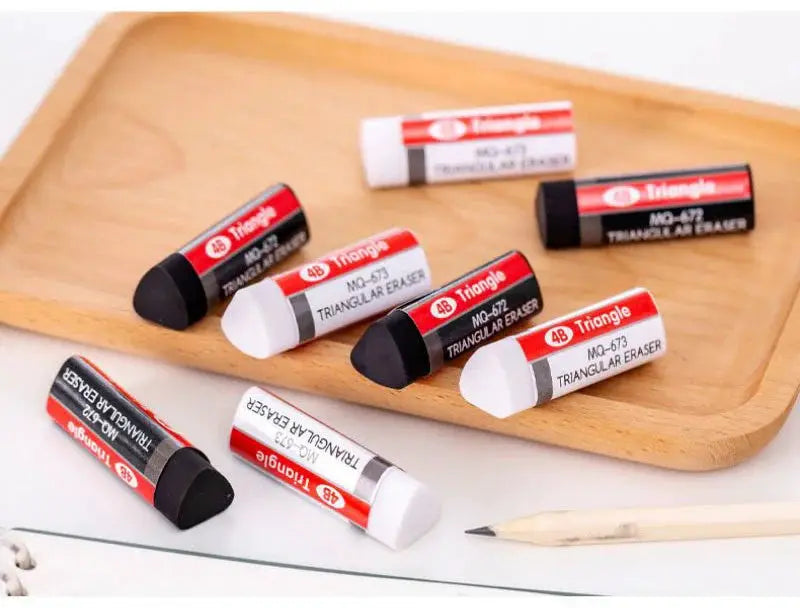 4B triangle erasers with red and white wrappers; assorted black and white erasers on a wooden tray, 8 pieces