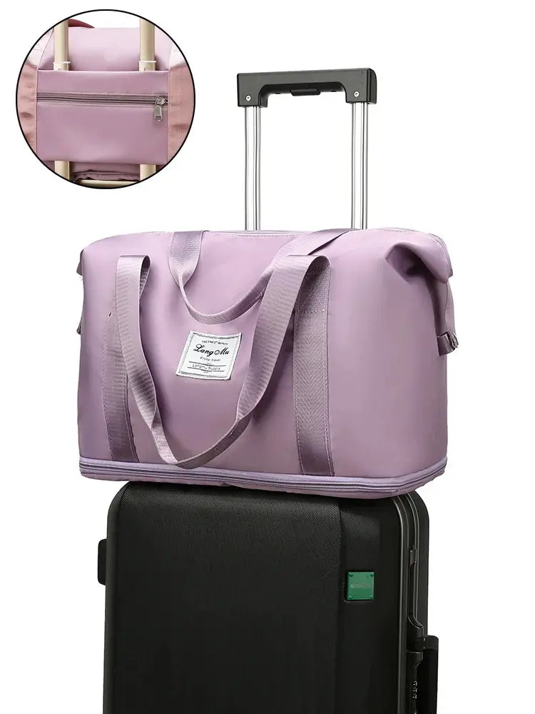 UNIXINU purple nylon waterproof carry-on duffle bag with handles, atop black rolling luggage (two-piece set).