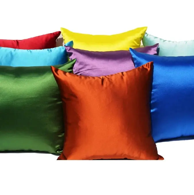 Satin pillow covers in assorted bright colors for sofa decor, featuring multiple cushions.