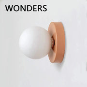 Wall lamp with peach iron backplate and white plastic ball shade, modern sconce light