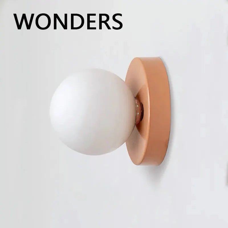 Wall lamp with peach iron backplate and white plastic ball shade, modern sconce light