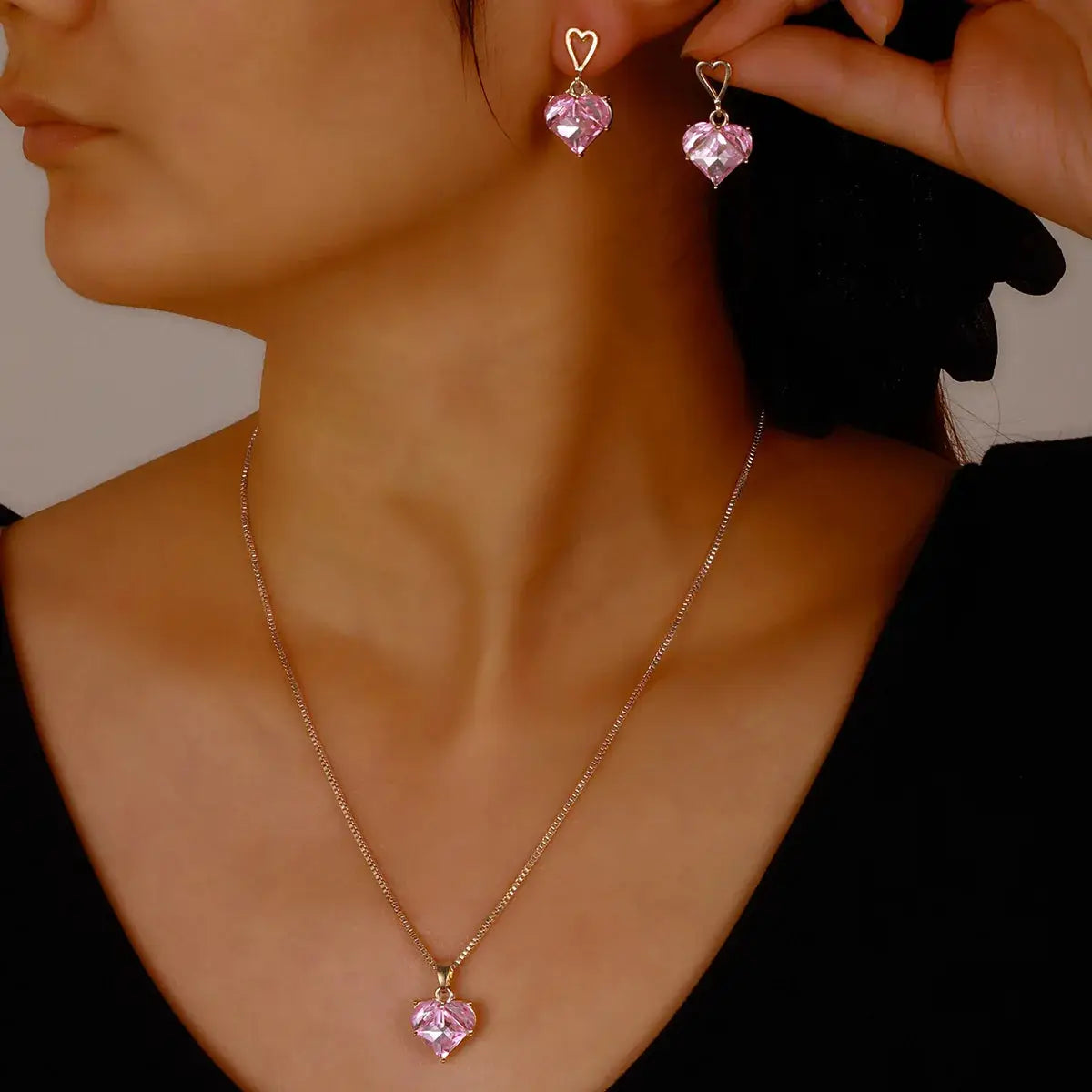 Peach heart pendant necklace with matching pink crystal heart earrings on gold-tone metal