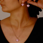 Peach heart pendant necklace with matching pink crystal heart earrings on gold-tone metal
