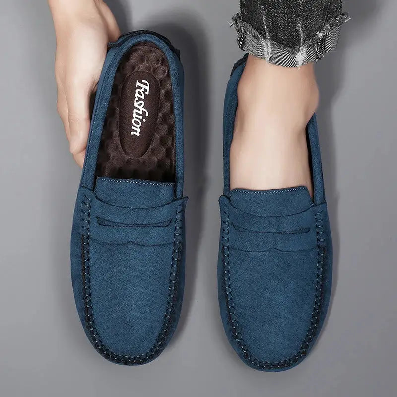 Pair of men's blue suede loafers slip-on driving shoes with moccasin-style stitching