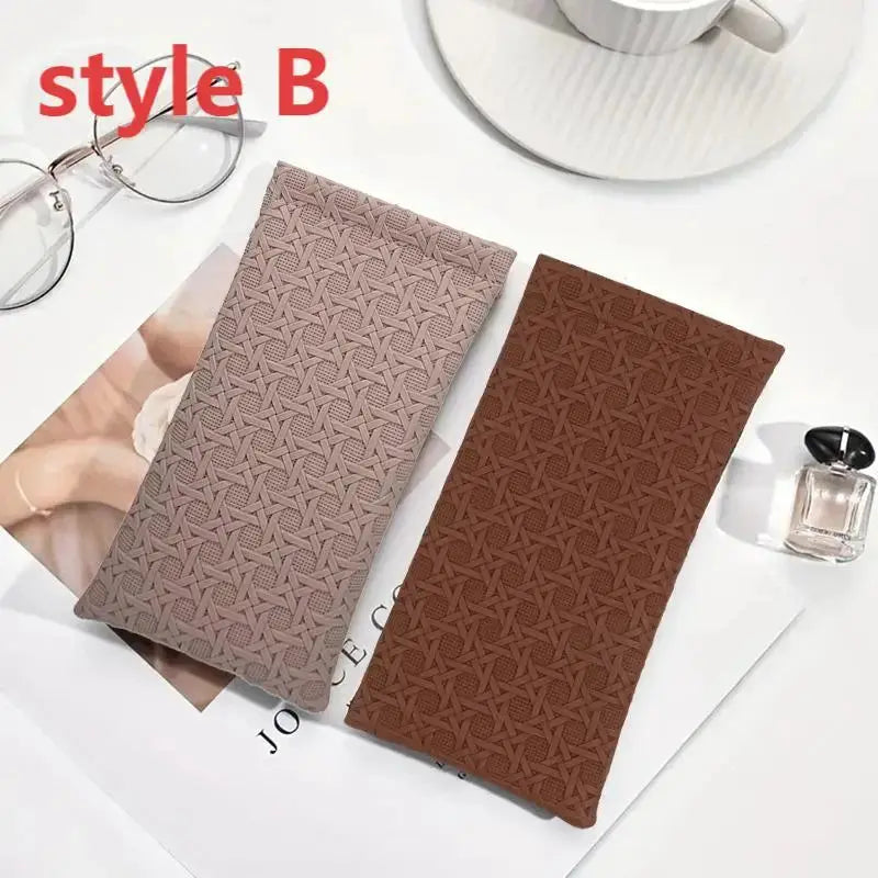 Two self-closing artificial leather long wallets in beige and brown with geometric embossed pattern.