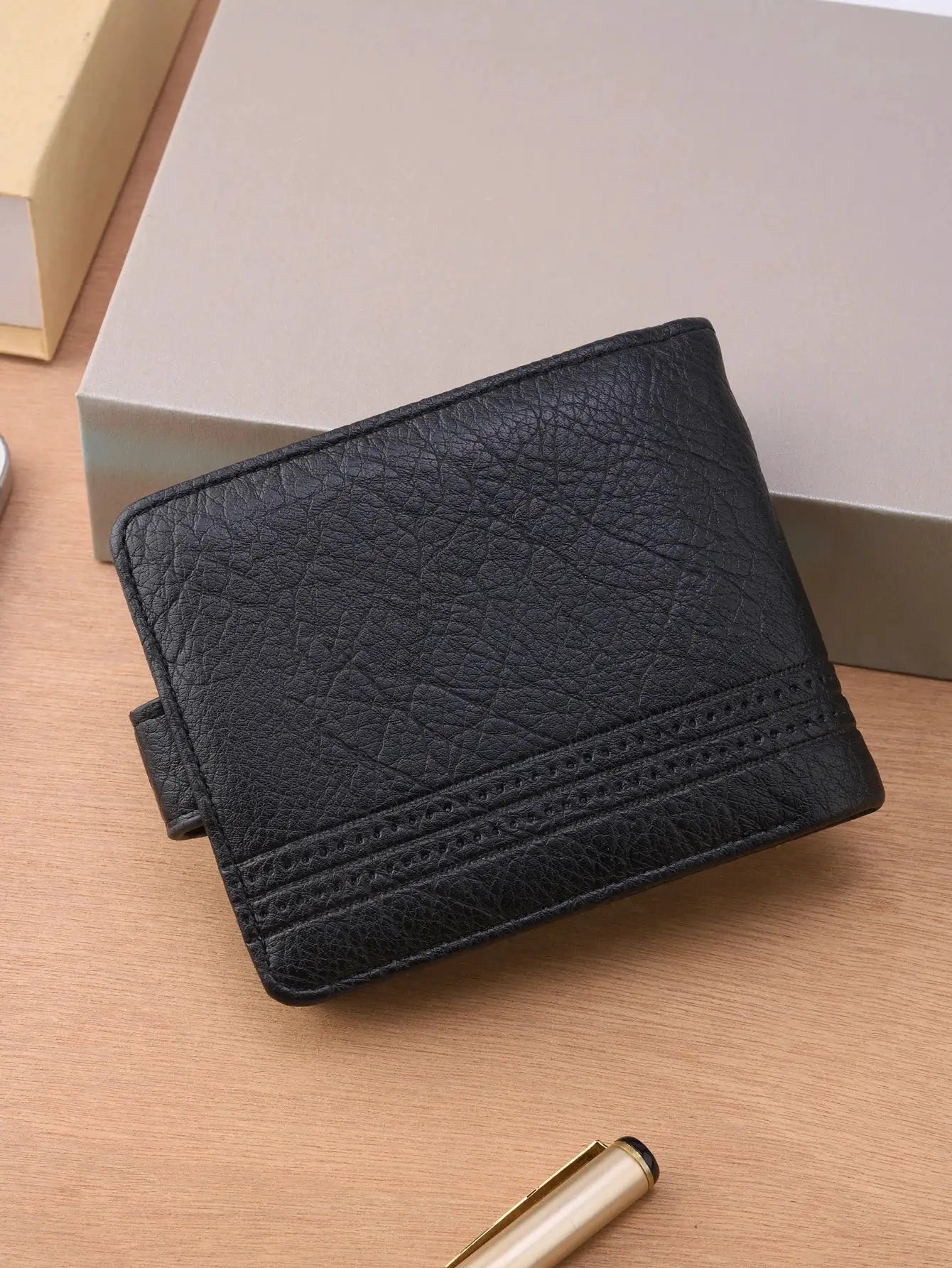Men's black textured leather wallet with slim card-holder design.