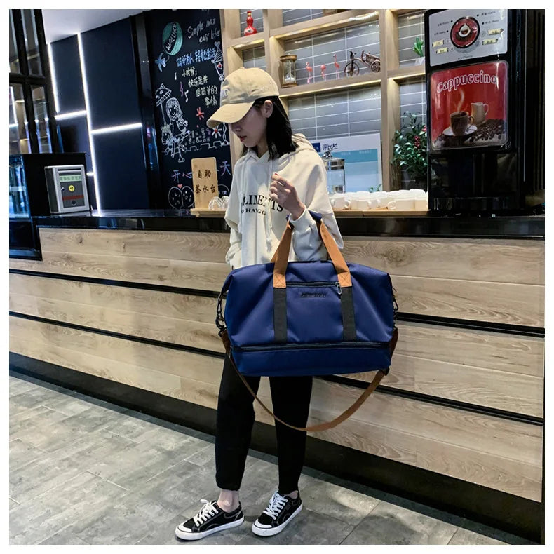 Large-capacity travel gym bag by Simples Market, blue with tan handles and detachable crossbody strap.