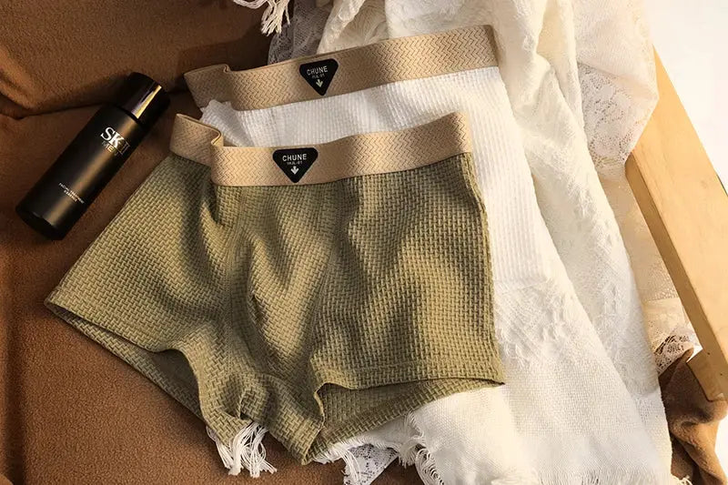 Two pairs of men's boxer shorts in khaki and white ice-silk textured fabric with CHUNE waistband