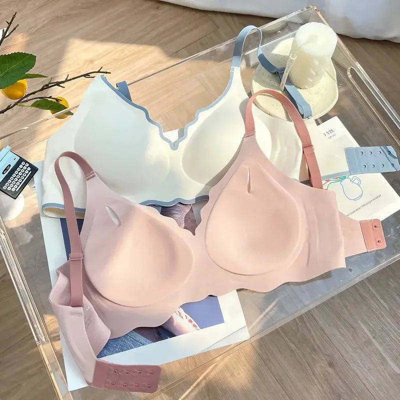 Push-up bra pair by Simples Market; No Trace, white with blue trim and nude-pink bras, back-closure
