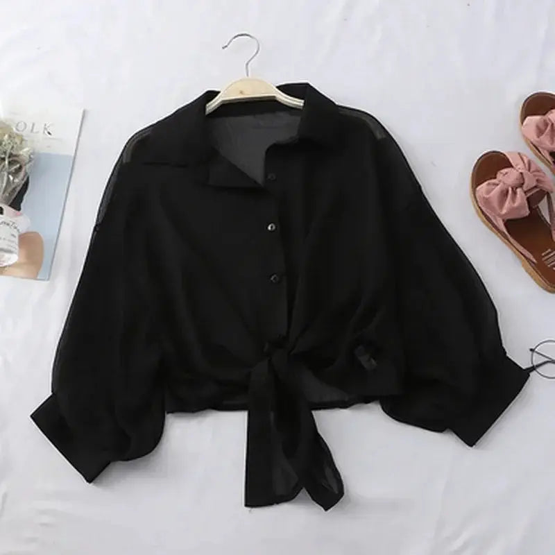 Casual black chiffon blouse with tie-front waist and bat-style sleeves.