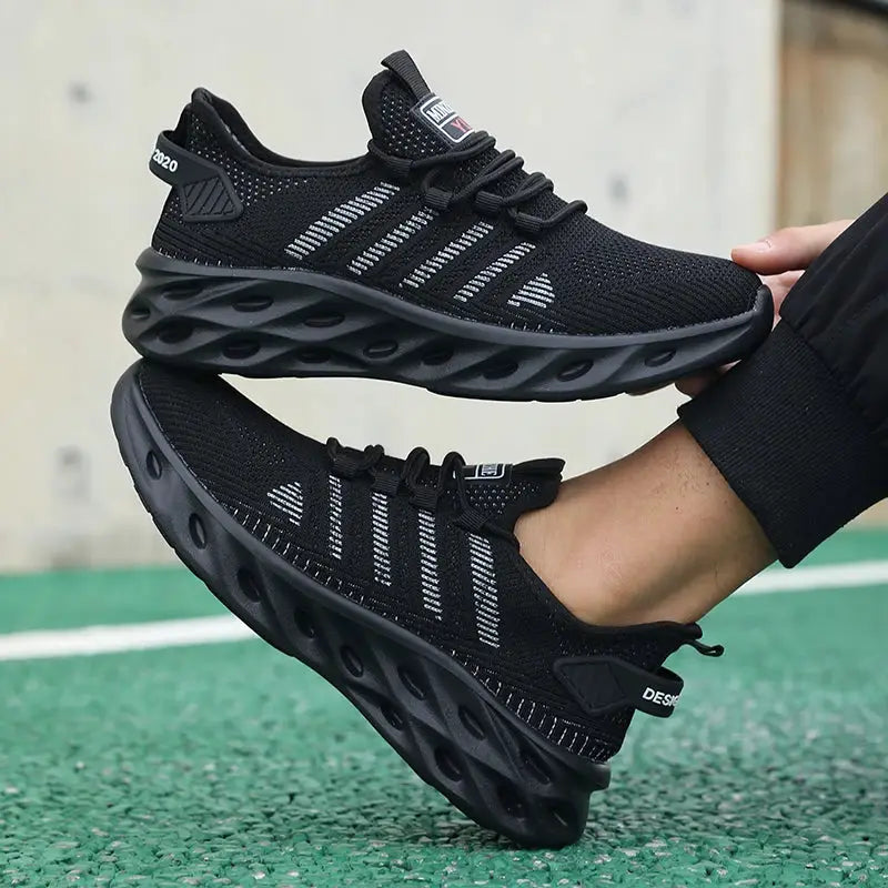 Two black knit unisex running sneakers with breathable mesh, striped side accents, and hollow circular sole design