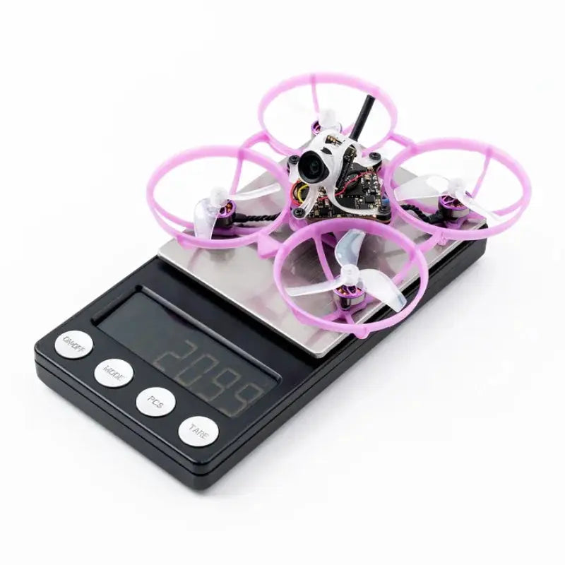 BETAFPV Air75 II ultralight whoop quadcopter with pink prop guards on a digital scale