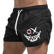 Men's black board shorts with white graphic smiley face print and drawstring