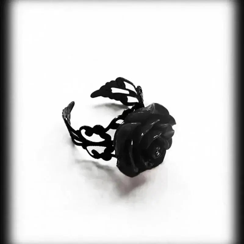Goth punk ring with black rose centerpiece and intricate openwork band