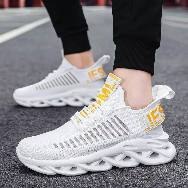 White unisex running sneakers by Simples Market, breathable knit upper with yellow heel tabs and sculpted sole.