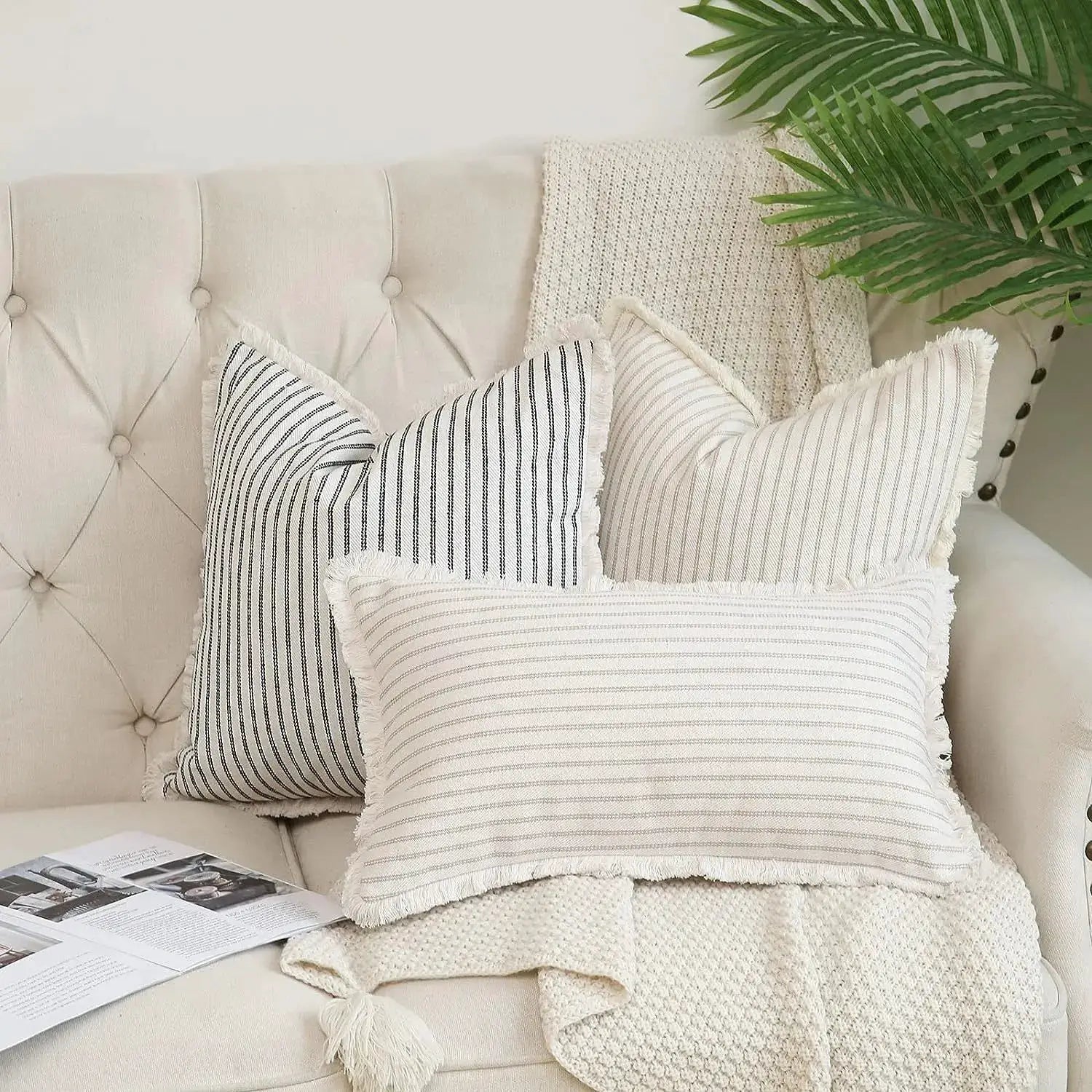 Simples Market wool striped cushion covers; square cream with dark stripes and fringed edges on a beige sofa