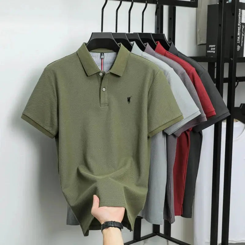 Polo shirt in olive green; 100% cotton with small pony embroidery, assorted colors on a rack