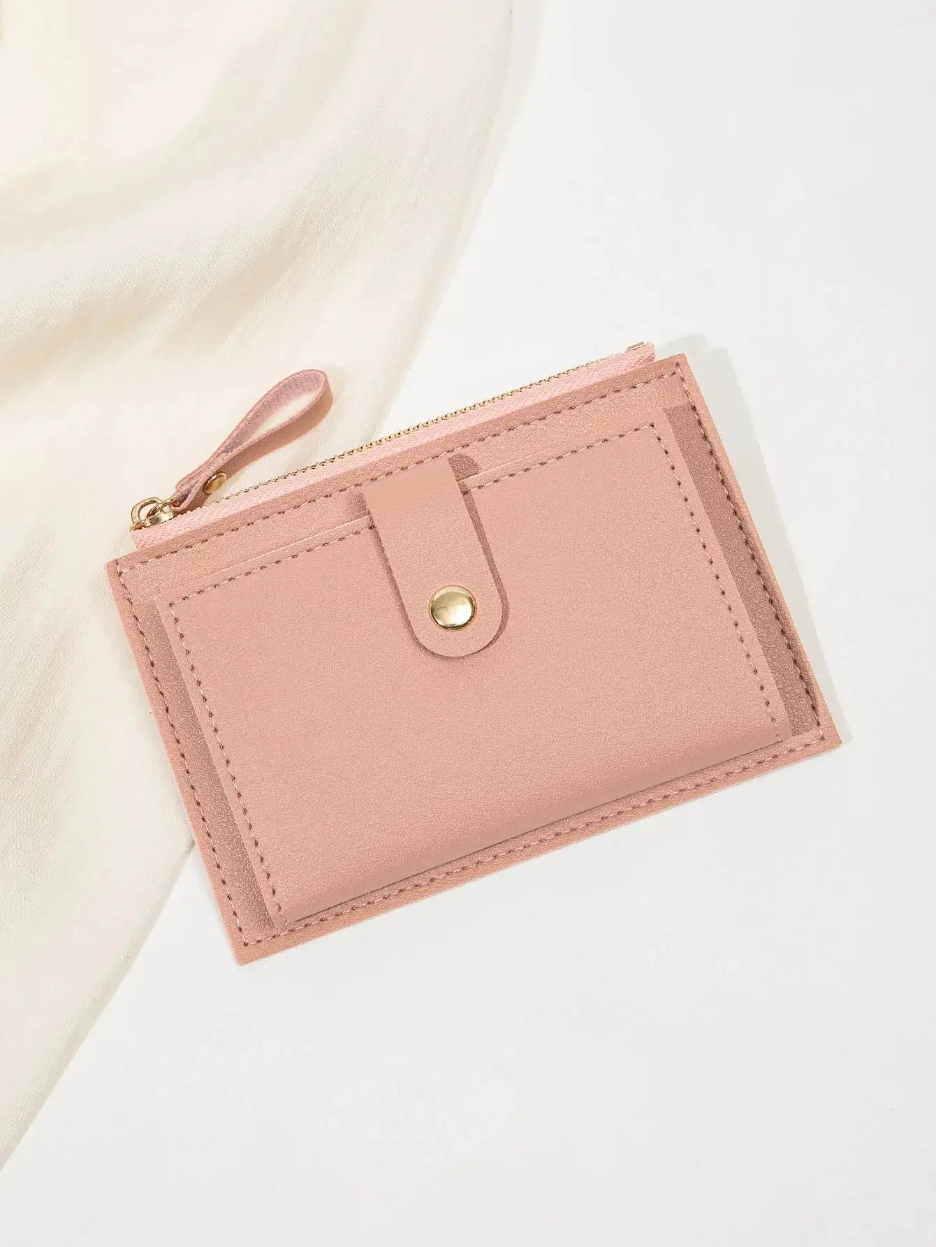 Card wallet in pink PU leather; minimalist, ultra-thin short design with zipper and wrist strap.