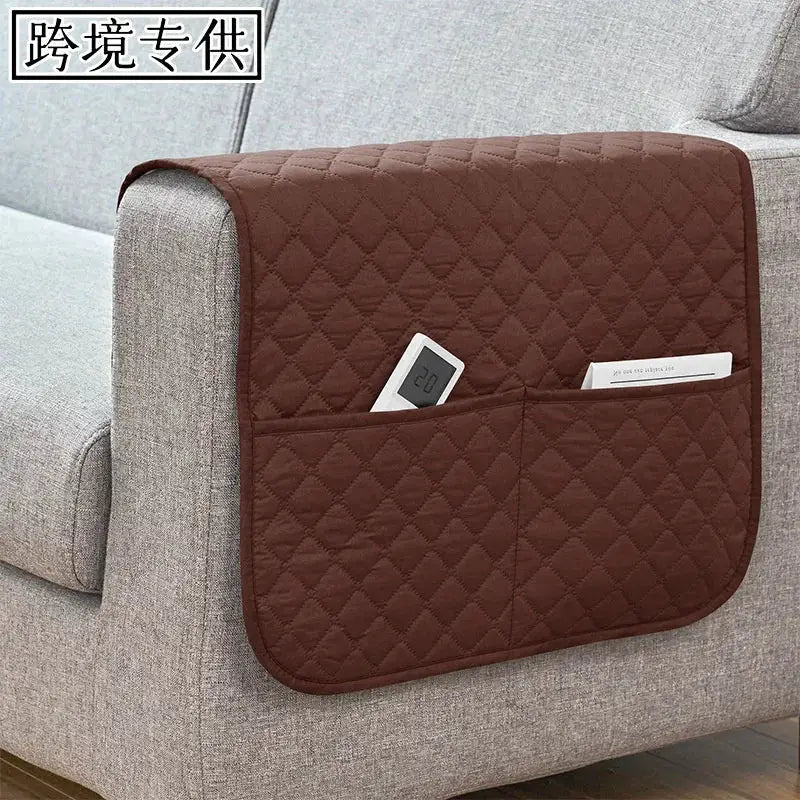 Brown quilted sofa armrest cover with front pockets for remote and cellphone, water-repellent slipcover