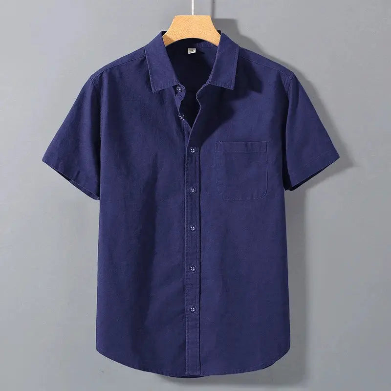 Navy blue men's short-sleeve cotton shirt with chest pocket and button-front.