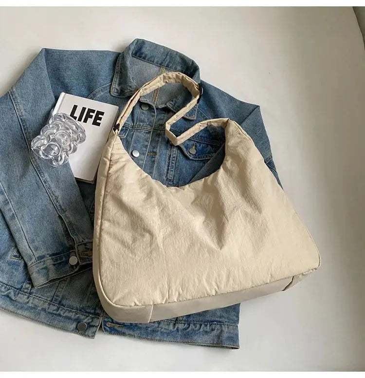 Soft-cloth beige shoulder bag by Simples Market, oversized casual tote atop a denim jacket