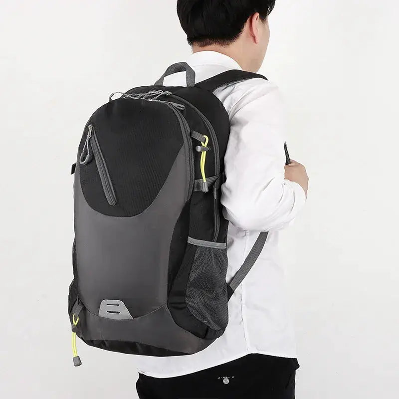 Classic 40L outdoor backpack in black and grey with yellow zipper accents.