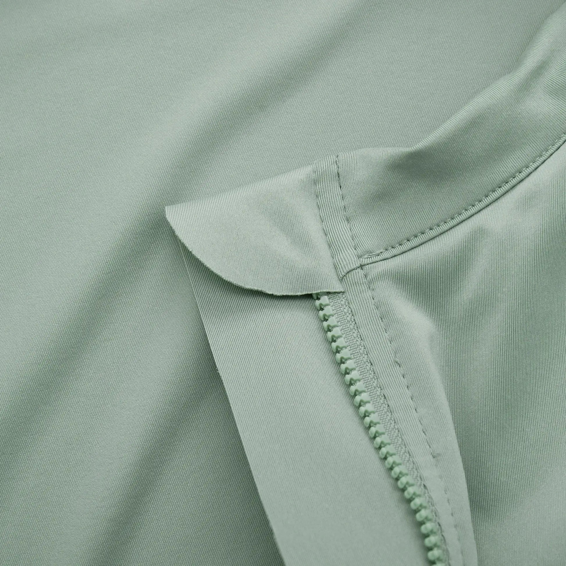 YKYWBIKE men's cycling jersey fabric close-up in mint green with zipper detail