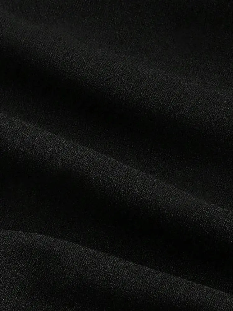 Women's shirt fabric close-up in black; smooth matte texture